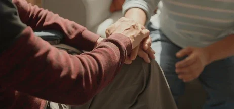 Two people holding hands in a moment of comfort and support, representing trauma and PTSD therapy at Inner Growth Pathways, Horsham
