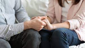 Two people holding hands in support, representing compassionate psychotherapy for anxiety, depression, trauma and relationship difficulties 