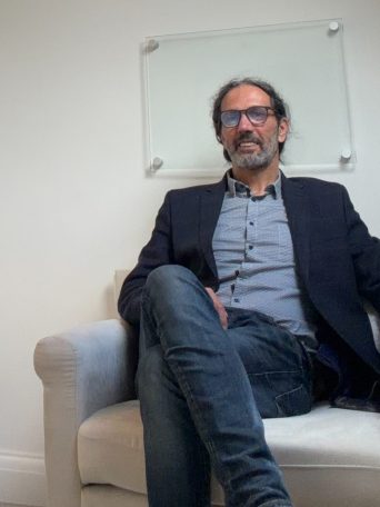 Gianluca Giordano, UKCP-registered psychotherapist in Horsham, West Sussex, seated in his therapy room at Inner Growth Pathways