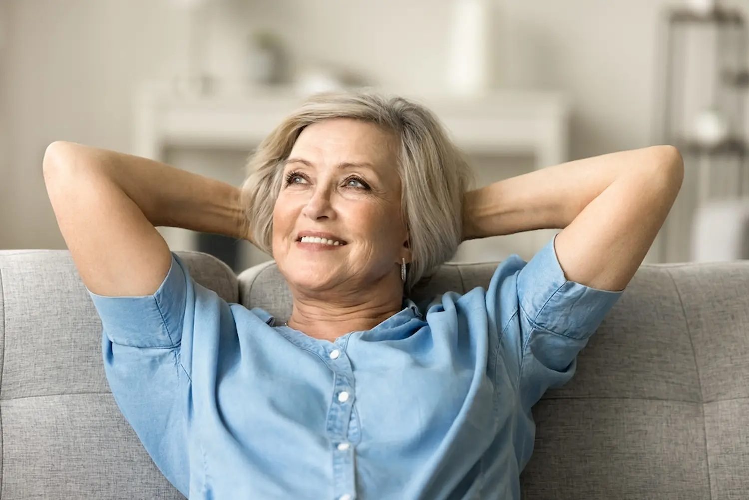 Woman relaxed and looking upward with a gentle smile, representing the hope and relief of taking the first step toward better mental health